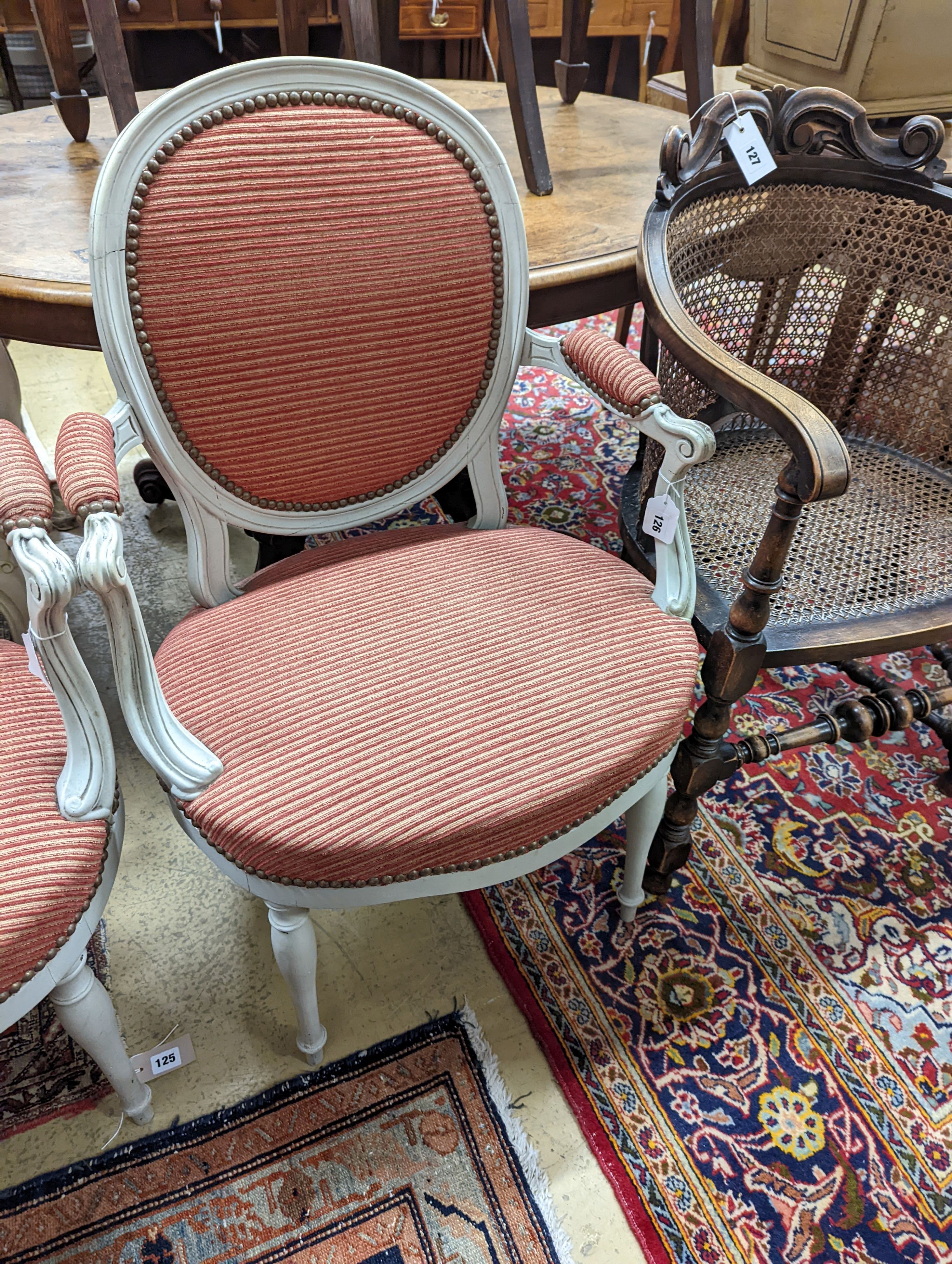 A pair of early 20th century French painted upholstered armchairs, width 59cm, depth 48cm, height 89cm